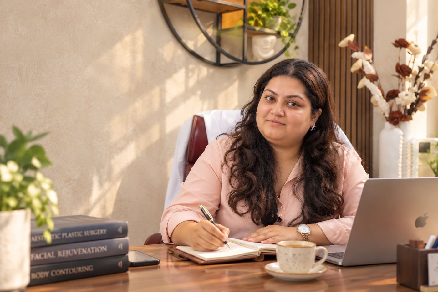 Dr. Swikriti Raniwala writing a treatment plan at her desk